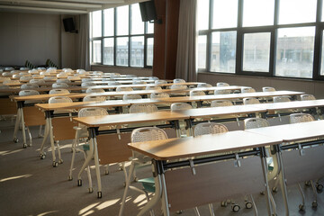 spacious conference room with rows of tables white chairs