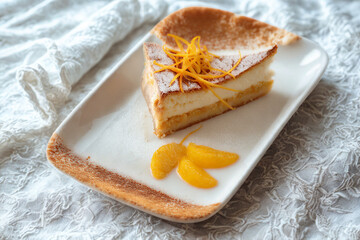 Delicious slice of orange cake with zest garnish