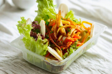 Fresh and vibrant salad in a clear container