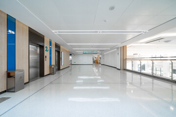 spacious lobby with multiple elevators, bright lights, and a polished floor in modern hospital