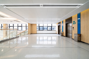 Obraz premium spacious lobby with multiple elevators, bright lights, and a polished floor in modern hospital