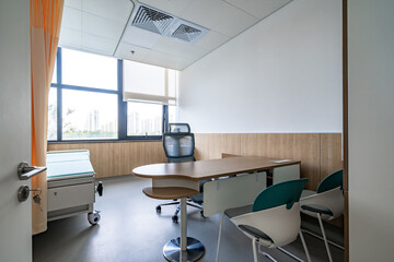 hospital examination room with a bed, desk