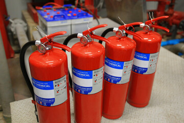 Fire extinguishers are located in the fire control room for building safety.