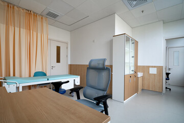 hospital examination room with a bed, desk
