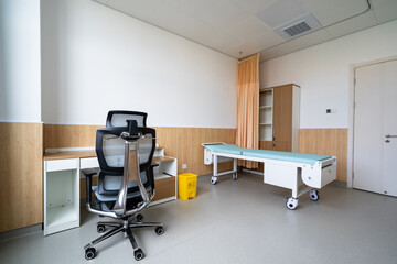 hospital examination room with a bed, desk