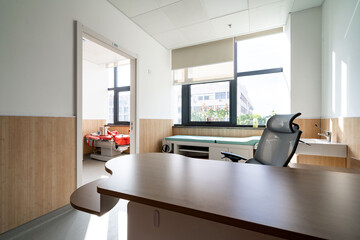 hospital examination room with a bed, desk