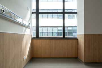 hospital room corner with wooden panels and large windows