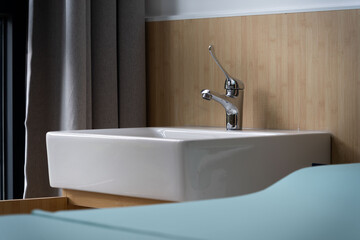 white sink with a chrome faucet