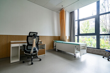 hospital examination room with a bed, desk