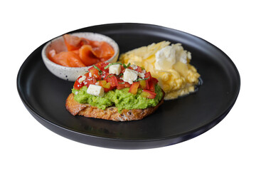 Delicious breakfast plate featuring avocado toast, scrambled eggs, and salmon