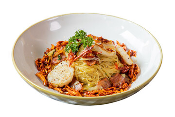 Delicious gourmet pasta dish served in a bowl. It features a rich sauce, garnished with fresh herbs, and various seafood additions