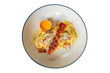 A delicious plate of carbonara with egg yolk and bacon