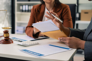 Teamwork of business lawyer meeting working hard about legal legislation in courtroom to help their...