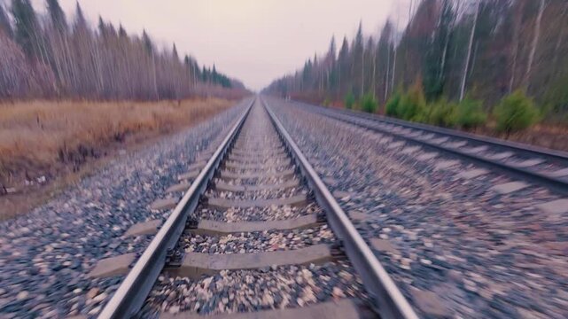 A man runs along the railway between the rails. Jogging on a double-track railway. From the first person.