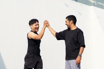 Asian Indonesian Men High Five After Sport Running Exercise Outdoors