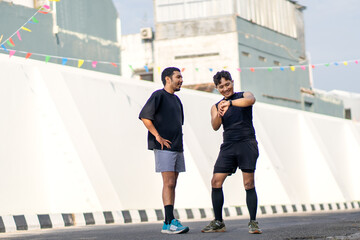 Asian Indonesian Men Checking Smartwatch After Running Exercise