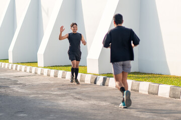 Asian Indonesian Men Running Together Outdoors for Exercise