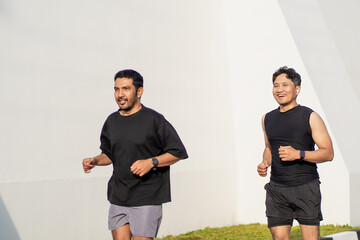 Asian Indonesian Men Running Together Outdoors for Exercise