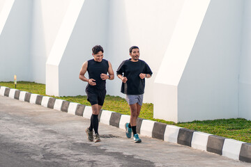 Asian Indonesian Men Running Together Outdoors for Exercise