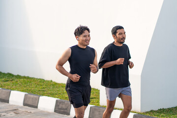 Asian Indonesian Men Running Together Outdoors for Exercise