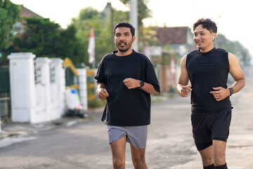 Asian Indonesian Men Running Together Outdoors for Exercise