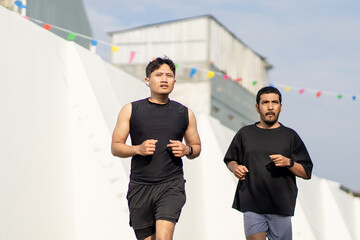 Asian Indonesian Men Running Together Outdoors for Exercise