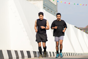 Asian Indonesian Men Running Together Outdoors for Exercise
