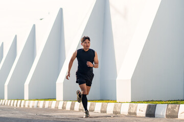 Asian Indonesian Man Running Alone Outdoors for Fitness