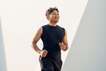 Asian Indonesian Man Running Alone Outdoors for Fitness