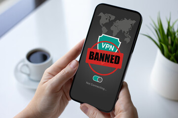 female hands holding phone with VPN banned on screen cafe