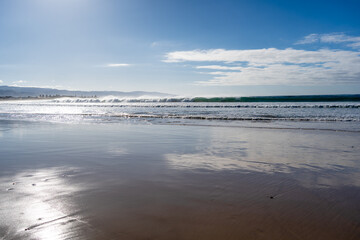 Sandy beach along the Great Ocean Road, Australia under cloudy sky