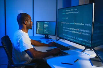 smart skilled introvert tester write typing operating data security evening office dark room