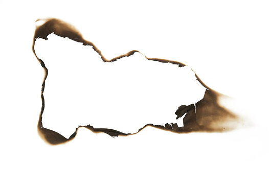 burned hole in white paper background texture. Burn in paper with brown edges and flames isolated on a transparent background.