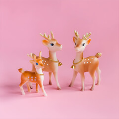 Obraz premium Christmas Reindeer Figurines on Pink Background