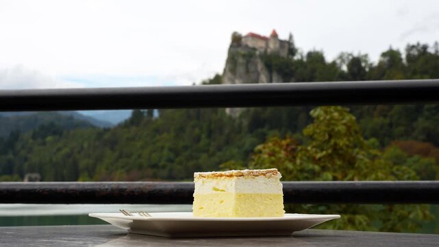 Closeup at Bled Cream Cake Krem&scaron;nita dessert, outdoor restaurant table, Slovenia