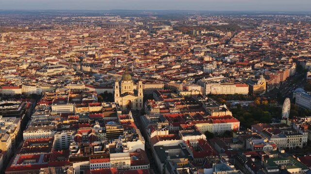 Aerial view of Budapest with St. Stephen&rsquo;s Basilica standing tall at the city&rsquo;s heart amid endless rooftops.