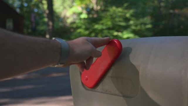Setting down the flag on a plastic mailbox.