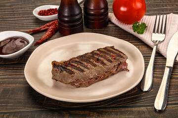 Grilled beef striploin steak with sauce