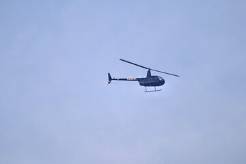 flying helicopter in blue sky