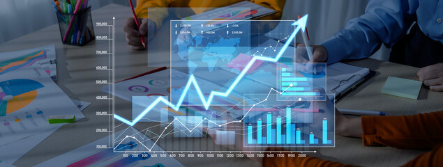 A professional business team collaborates in a modern office, analyzing growth data and using digital interfaces, charts, and graphs to enhance decision-making and strategy. Scalp