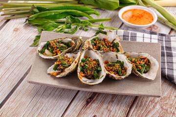 Gournet grilled oysters with onion and peanut