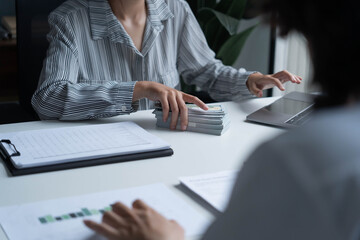 Fototapeta premium Accountants work in the office, calculating and counting cash