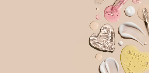 samples of cosmetic care products smear of cream texture on a beige background