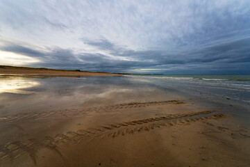 Tractor tracks on the beach of Bricqueville-sur-Mer village in Normandy region