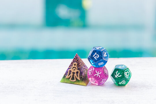 Guardian angle oragone pyramid with Astrology dice over blurred background, energy healing and protection with fortune telling tool 