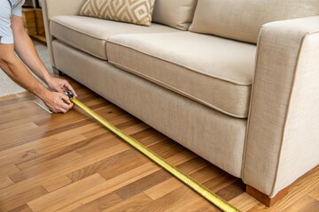 person measure furniture with ruler for interior decor plan