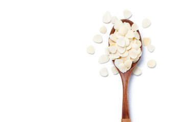 sliced ​​almonds in a wooden spoon isolated on white background, top view