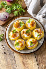 Potato tartlets filled with cottage cheese and marinated mushrooms.