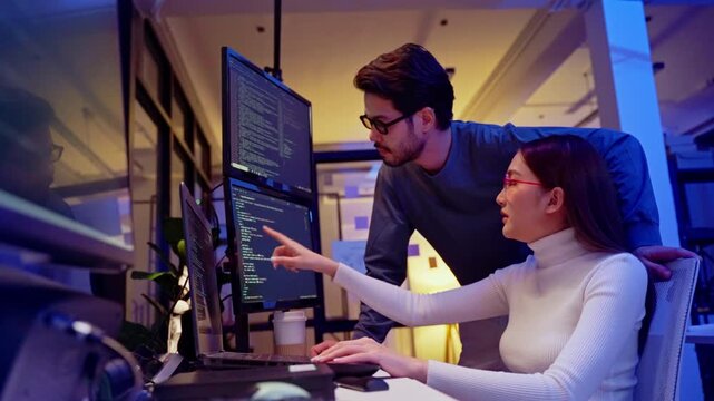Asian software engineer or programmer team working late in development office,problem solving or algorithm of ai assistant helping for work.software developer,digital technology security concept