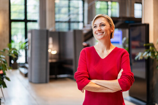 Confident businesswoman smiling in modern office